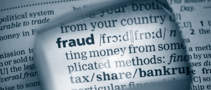 Magnifying glass on fraud definition