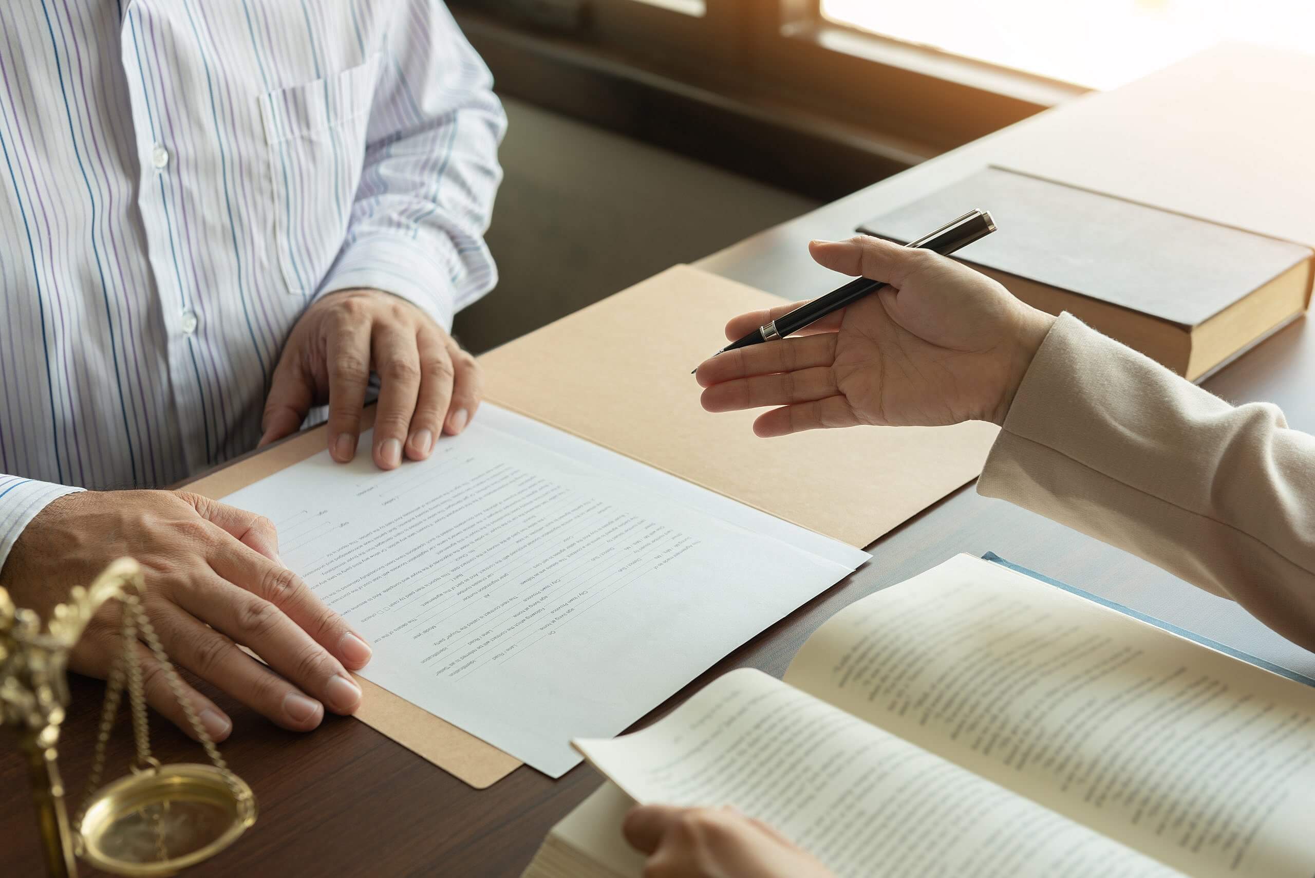 Attorney and man discussing legal documents