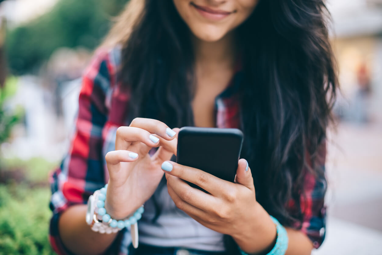 teenage girl texting on phone