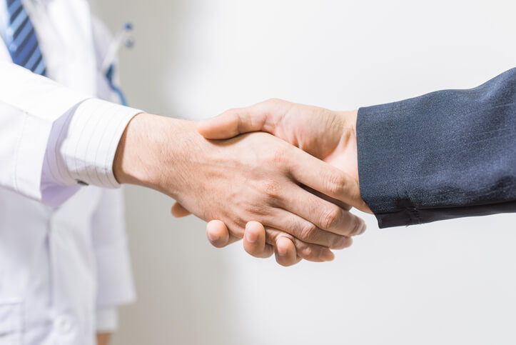 Doctor shaking hands with attorney