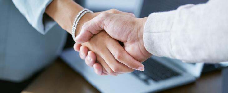 female attorney shaking hands with a man