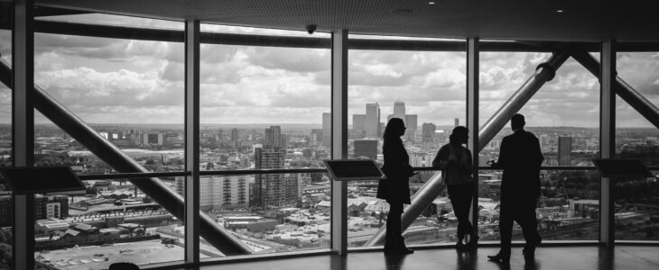 businesspeople in front of a window